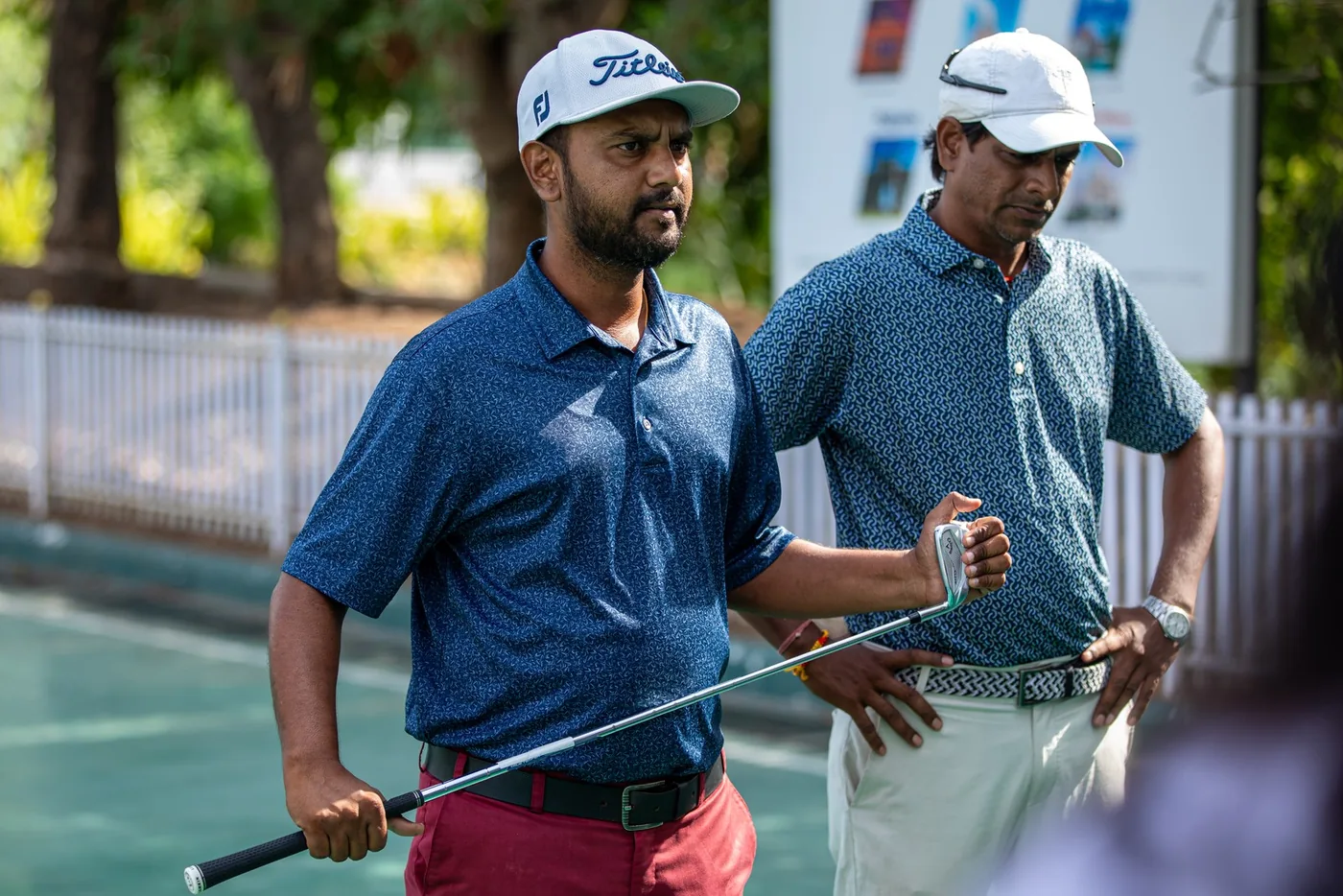 Participants with golf clubs at the GCC Mixer practice range