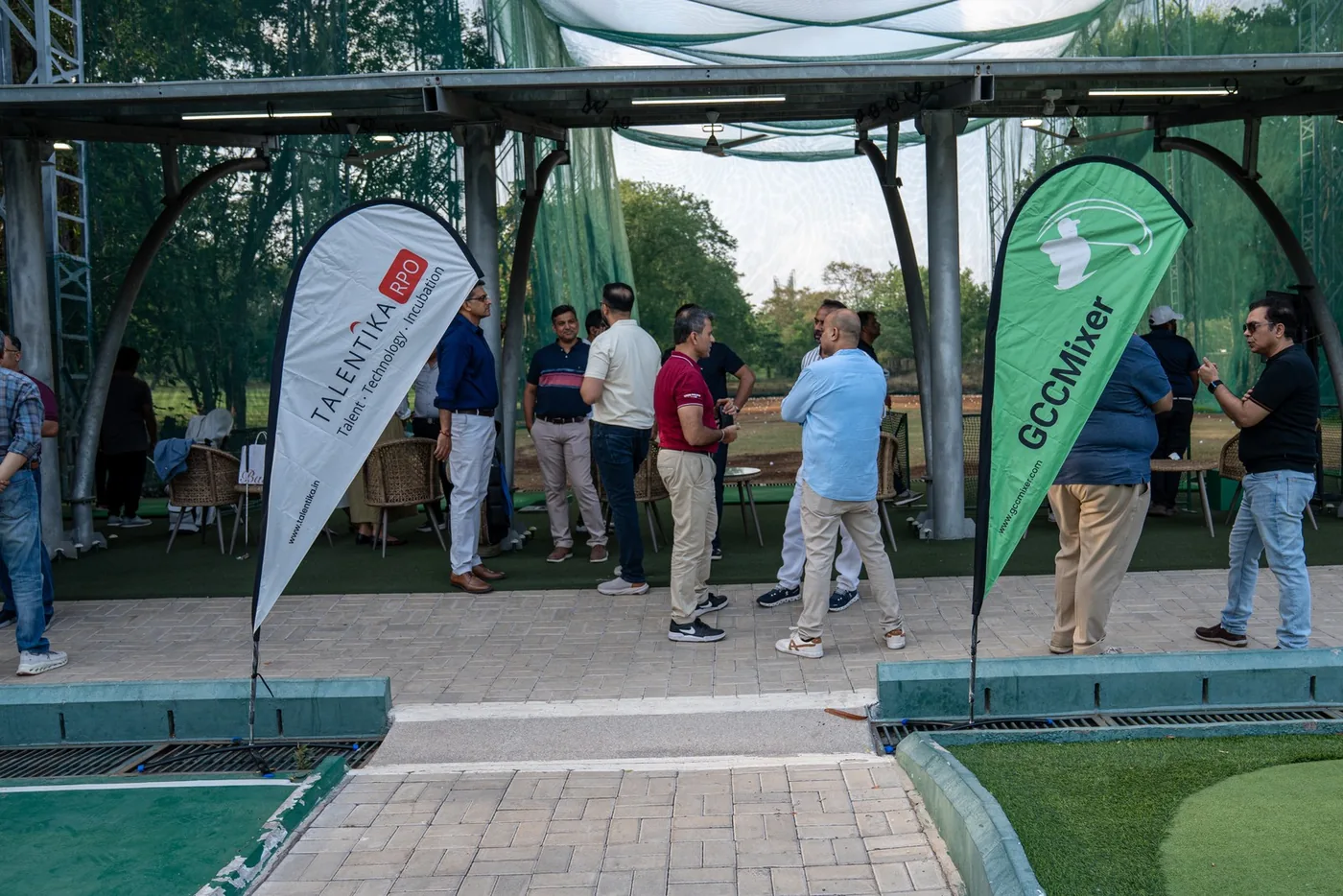 Guests gathering between GCC Mixer flags at Yerawada Golf Club